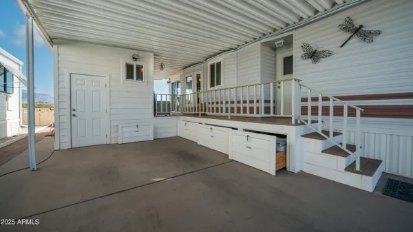 a view of a chairs and table in the balcony