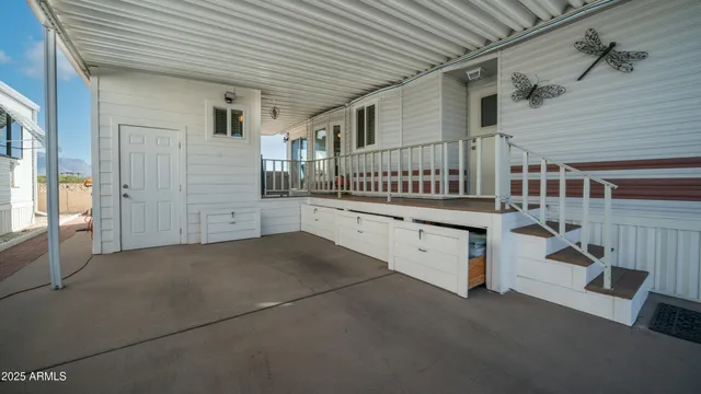 a view of a chairs and table in the balcony