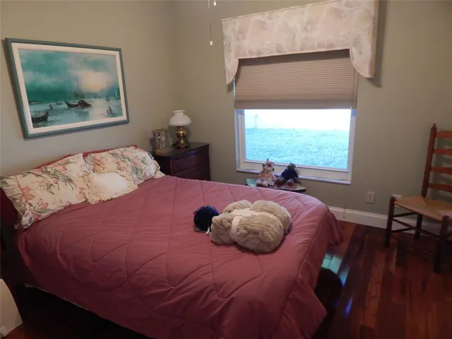 a bedroom with a bed and a large window