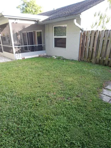 a view of a house with a yard and sitting area