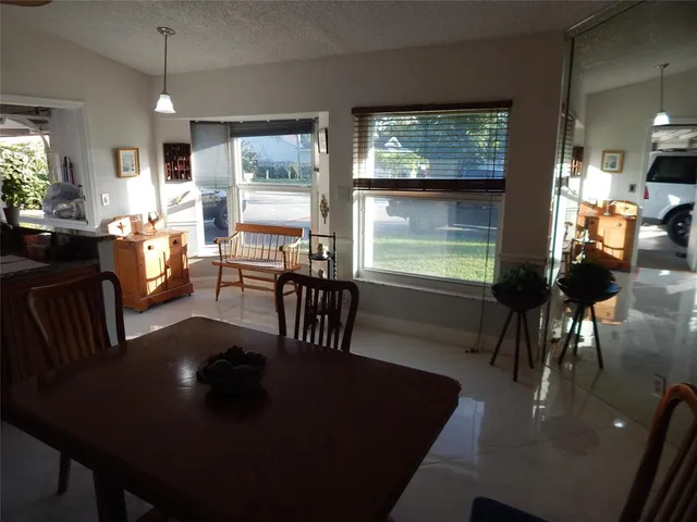 a view of a dining room with furniture window and outside view