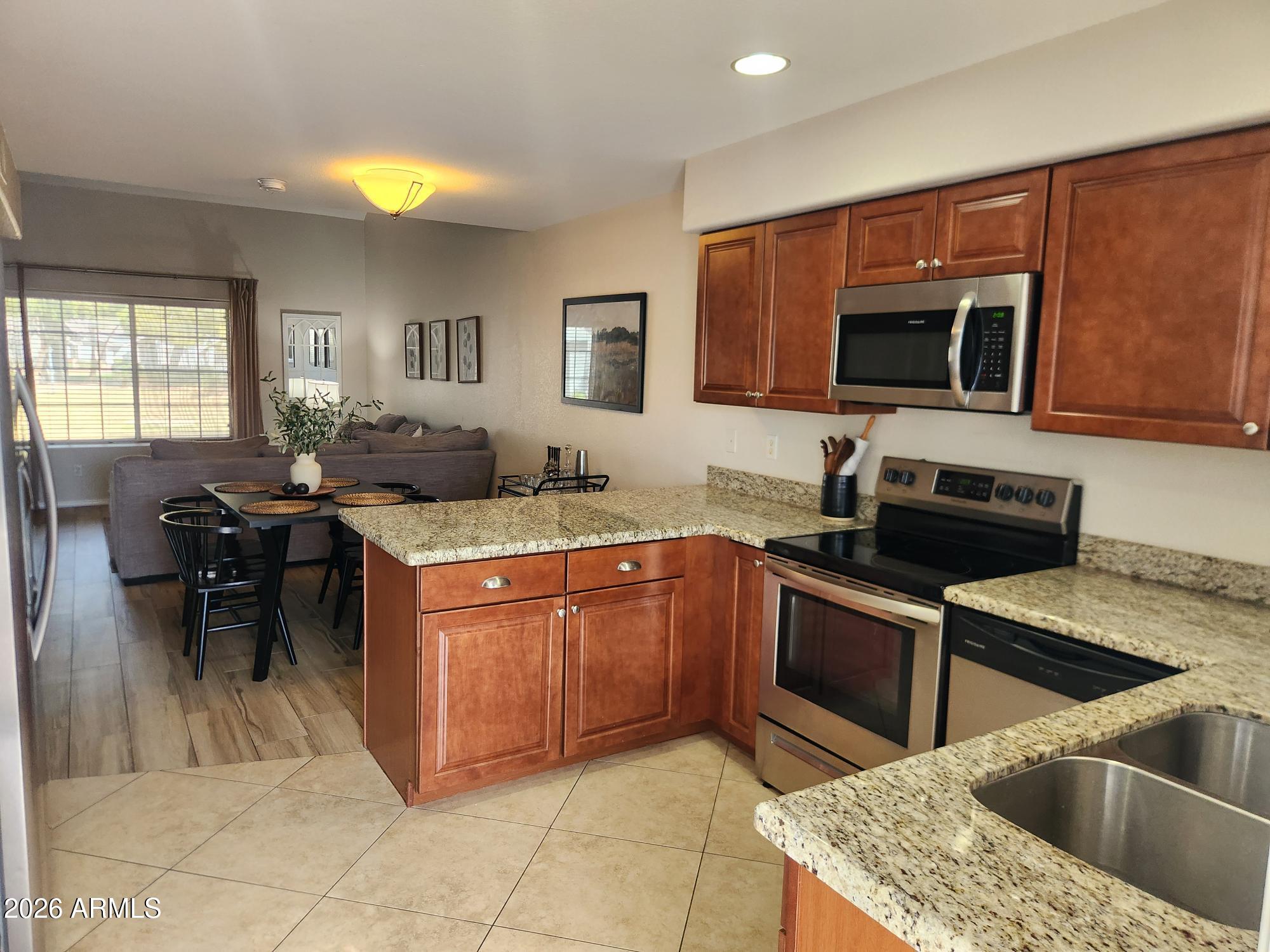 860 North McQueen Road, Unit 1145 Chandler, AZ 85225 - Photo 12 of 63 a kitchen with a stove sink and microwave