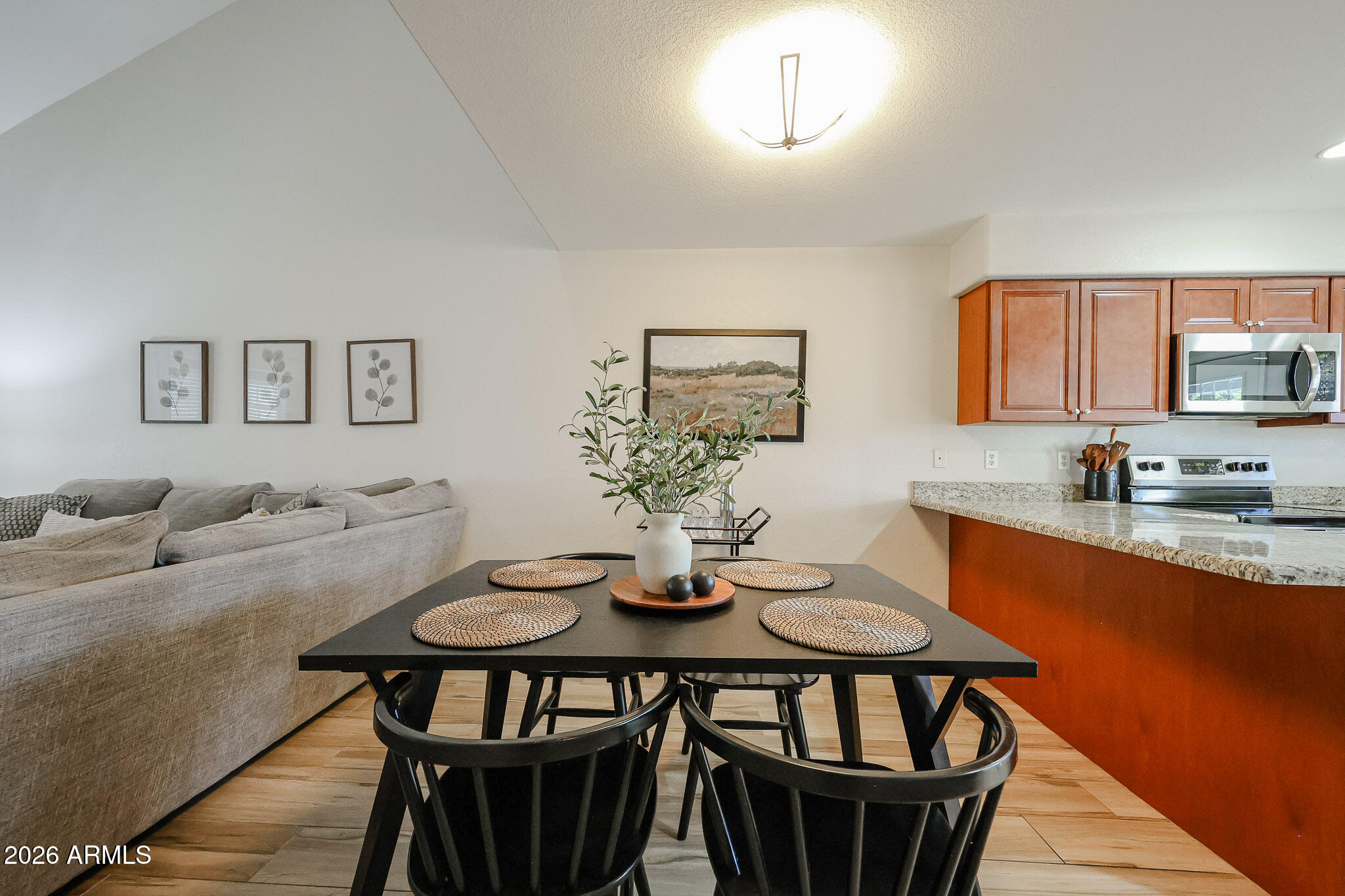 860 North McQueen Road, Unit 1145 Chandler, AZ 85225 - Photo 13 of 63 a view of a dining room with furniture and wooden floor