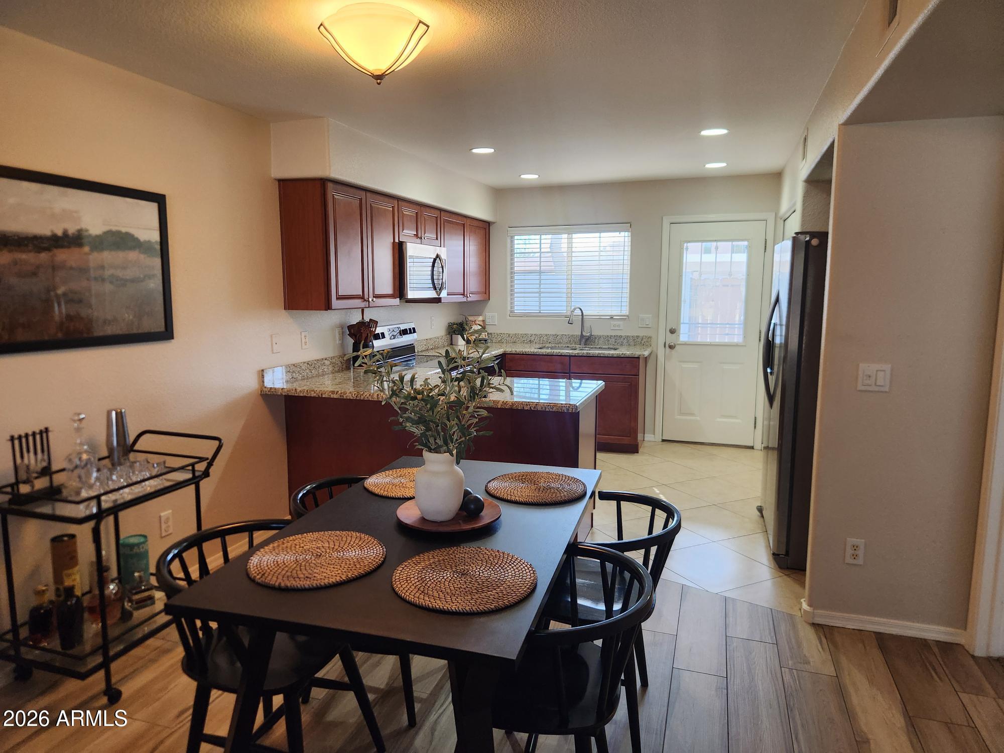 860 North McQueen Road, Unit 1145 Chandler, AZ 85225 - Photo 15 of 63 a view of a dining room with furniture and wooden floor