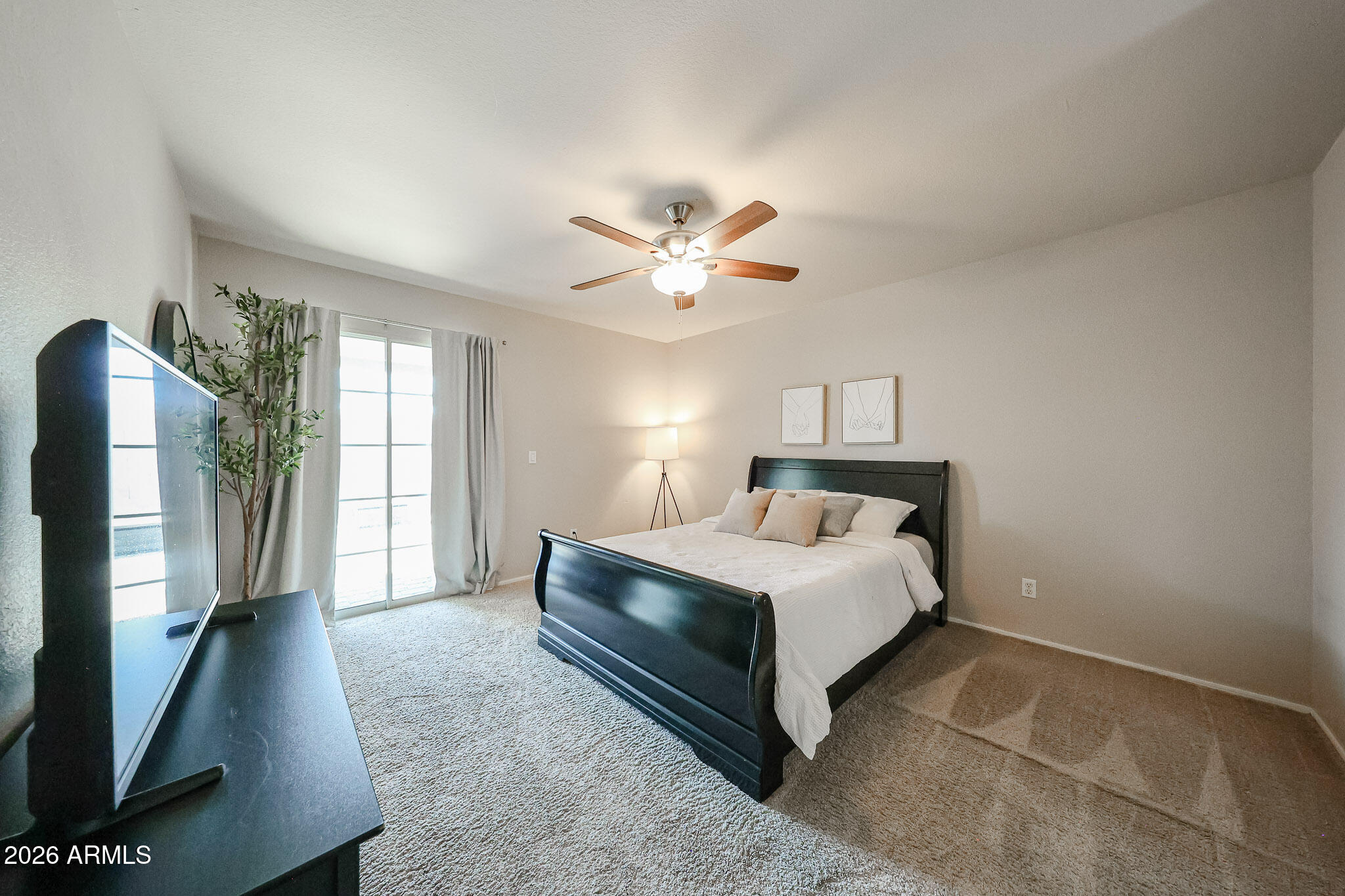 860 North McQueen Road, Unit 1145 Chandler, AZ 85225 - Photo 19 of 63 a spacious bedroom with a bed and a flat screen tv