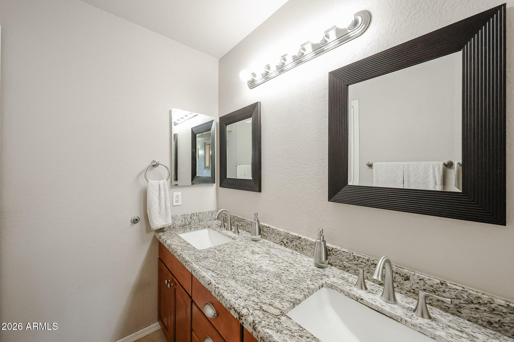 860 North McQueen Road, Unit 1145 Chandler, AZ 85225 - Photo 25 of 63 a bathroom with a granite countertop sink and a mirror