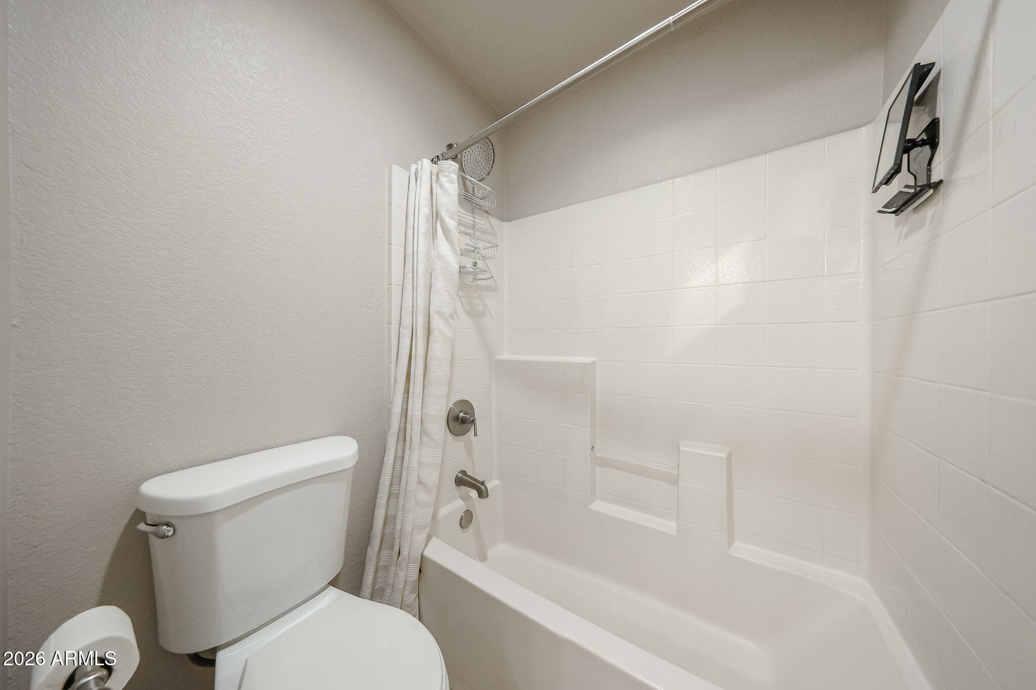 860 North McQueen Road, Unit 1145 Chandler, AZ 85225 - Photo 27 of 63 a white toilet sitting next to a bath tub and shower