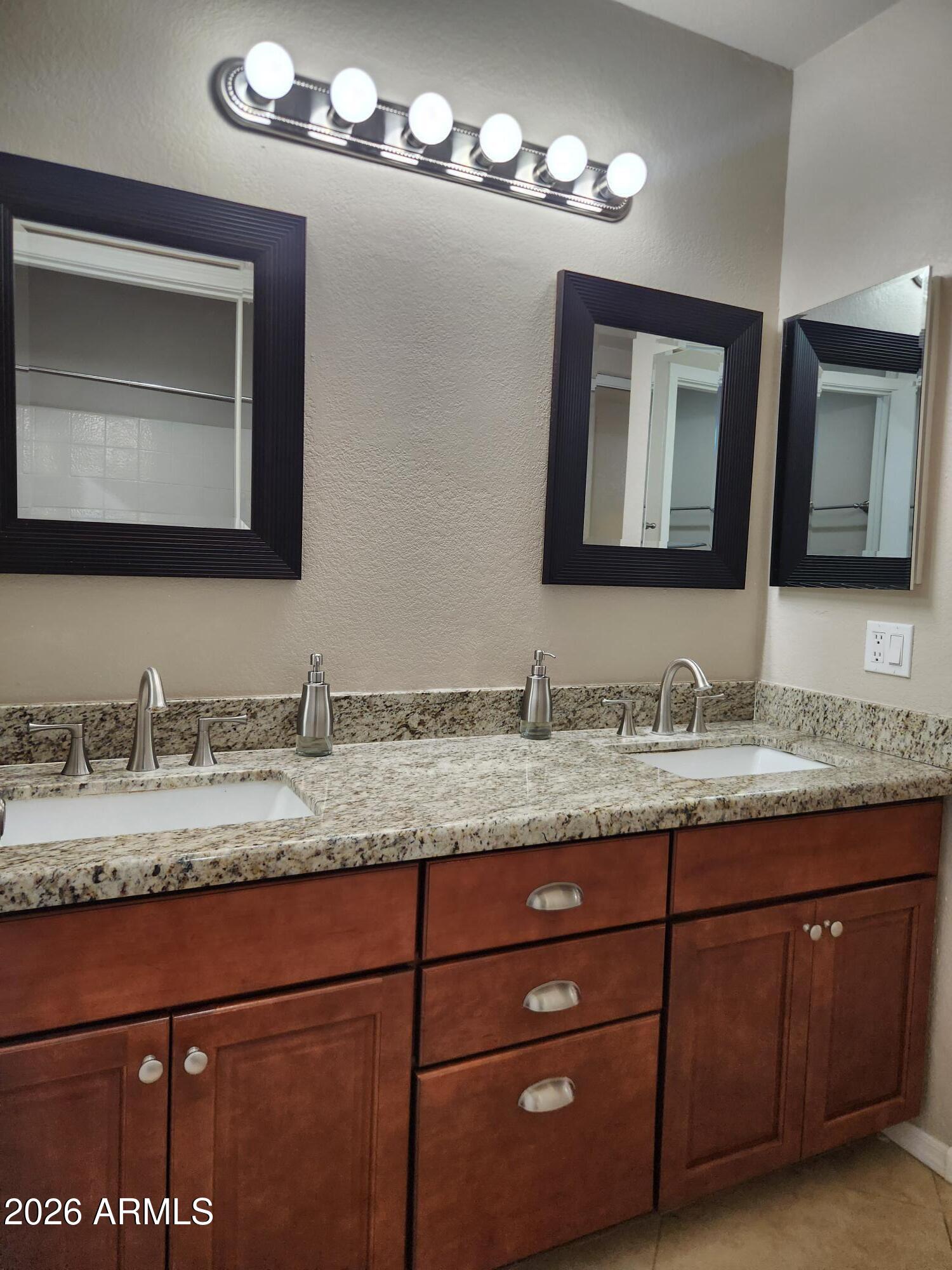 860 North McQueen Road, Unit 1145 Chandler, AZ 85225 - Photo 28 of 63 a bathroom with a granite countertop sink double and mirror