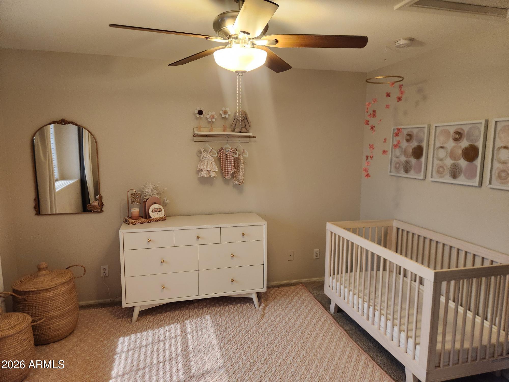 860 North McQueen Road, Unit 1145 Chandler, AZ 85225 - Photo 36 of 63 a bedroom with a bed and a chandelier