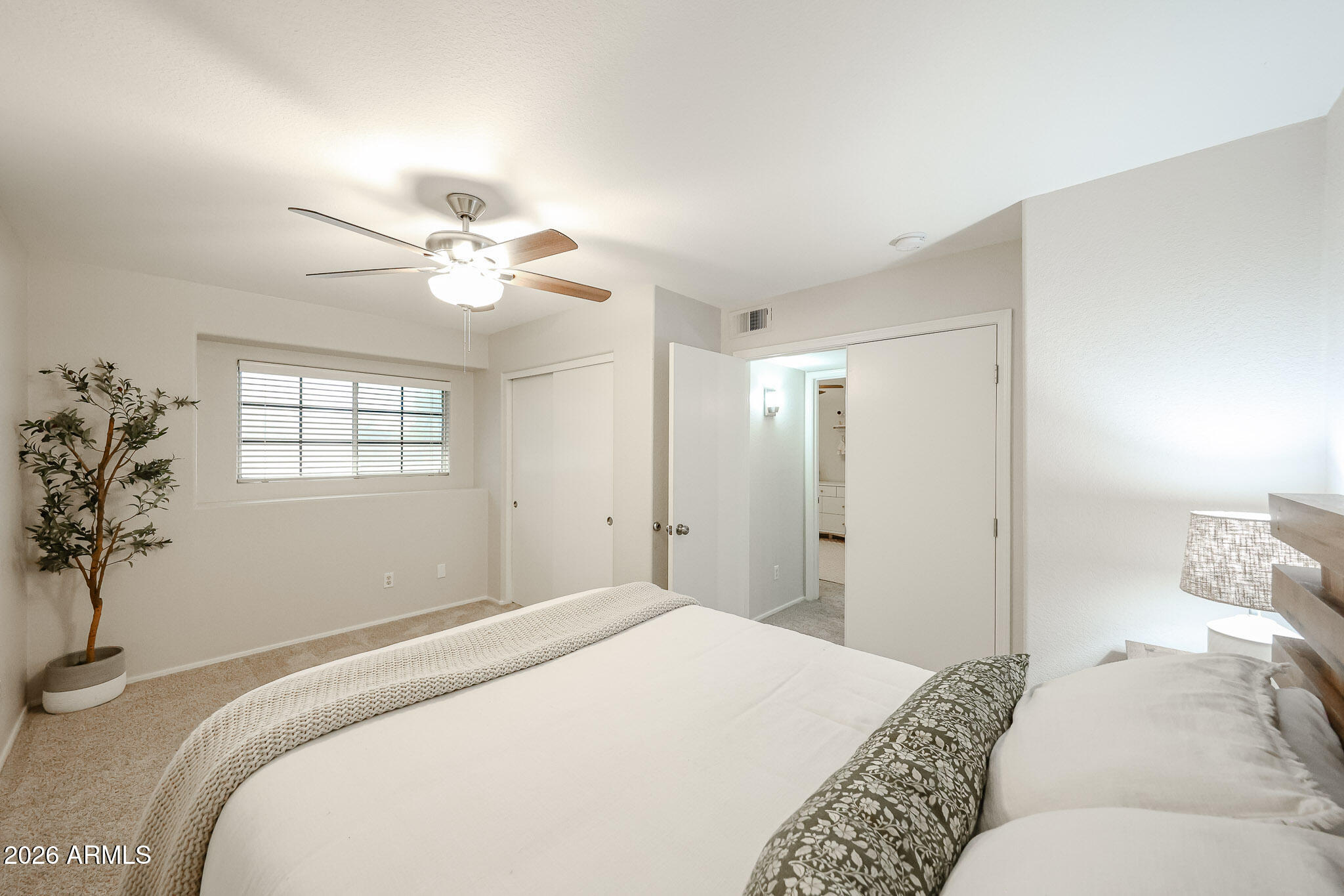 860 North McQueen Road, Unit 1145 Chandler, AZ 85225 - Photo 38 of 63 a bedroom with a large bed and a chandelier