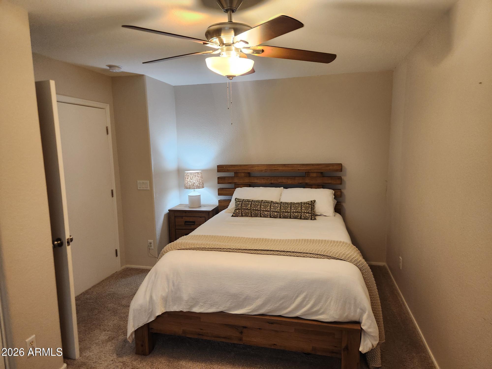 860 North McQueen Road, Unit 1145 Chandler, AZ 85225 - Photo 40 of 63 a bedroom with a bed and a chandelier