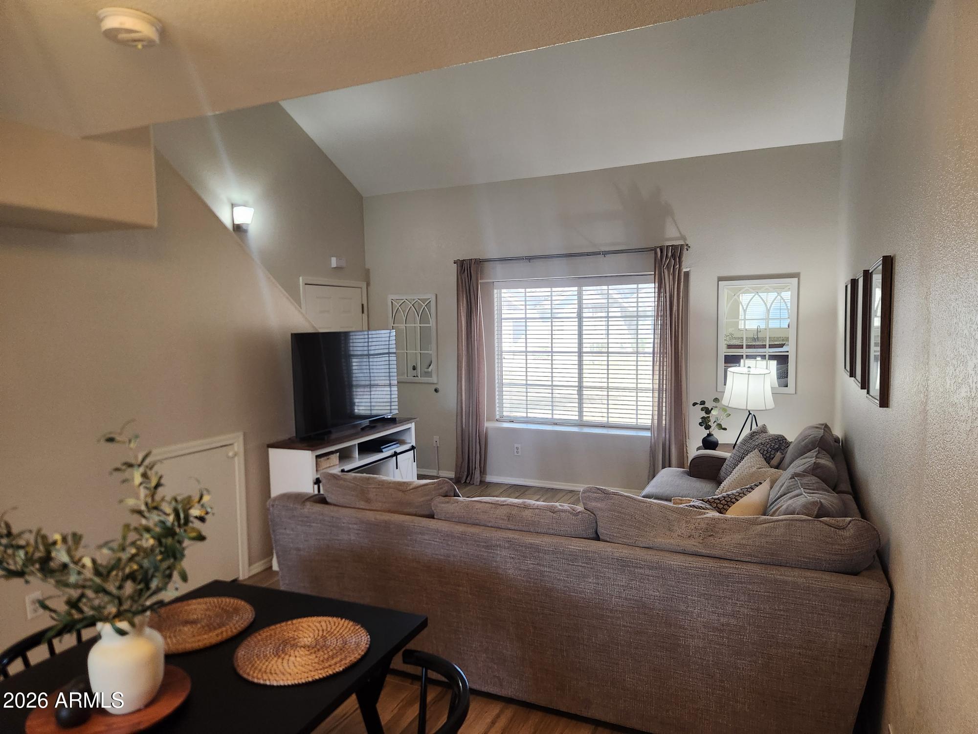 860 North McQueen Road, Unit 1145 Chandler, AZ 85225 - Photo 5 of 63 a living room with furniture and a flat screen tv