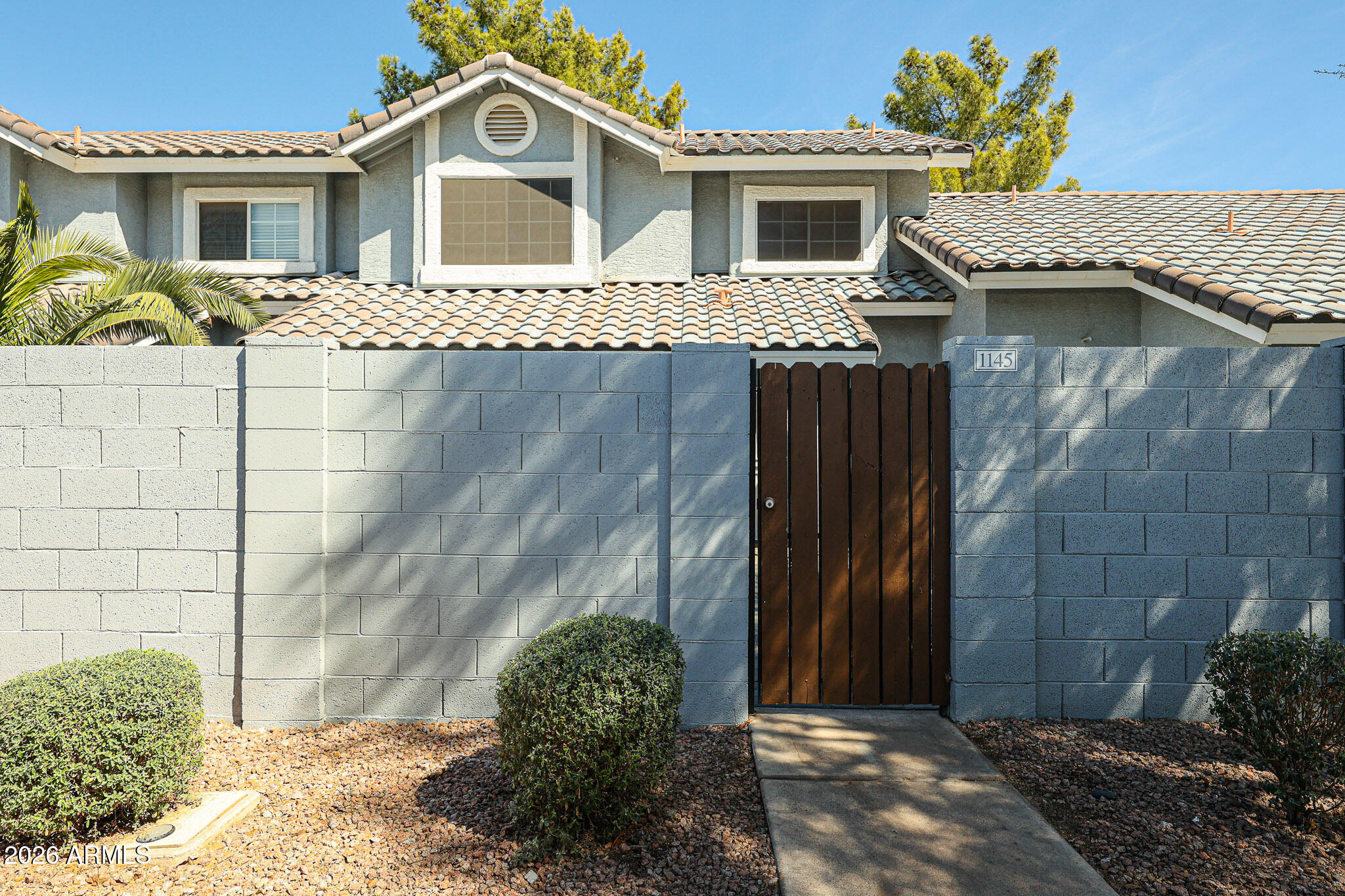 860 North McQueen Road, Unit 1145 Chandler, AZ 85225 - Photo 52 of 63 a front view of a house with a garden