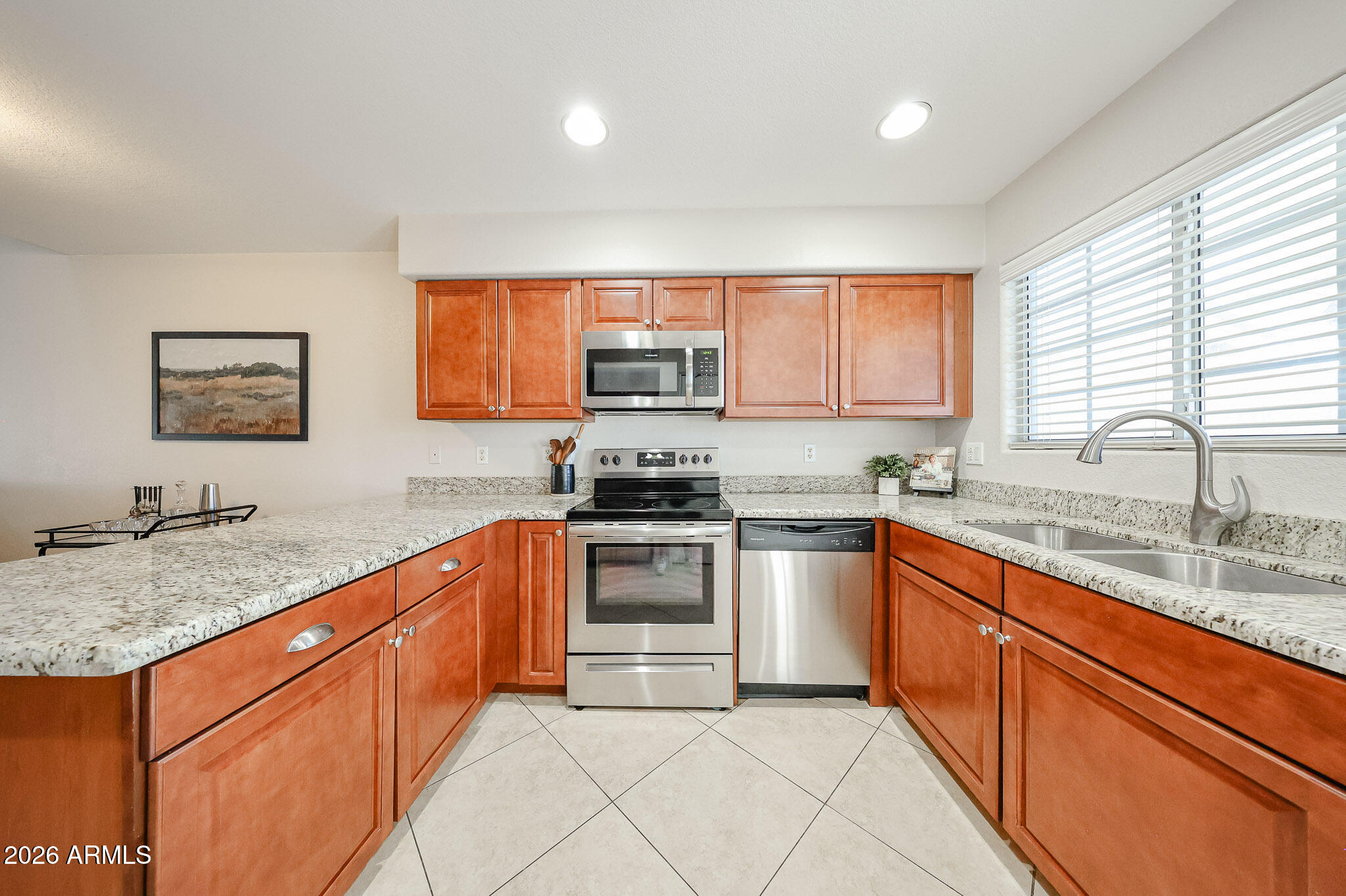 860 North McQueen Road, Unit 1145 Chandler, AZ 85225 - Photo 6 of 63 a kitchen with stainless steel appliances granite countertop a stove a sink and a microwave