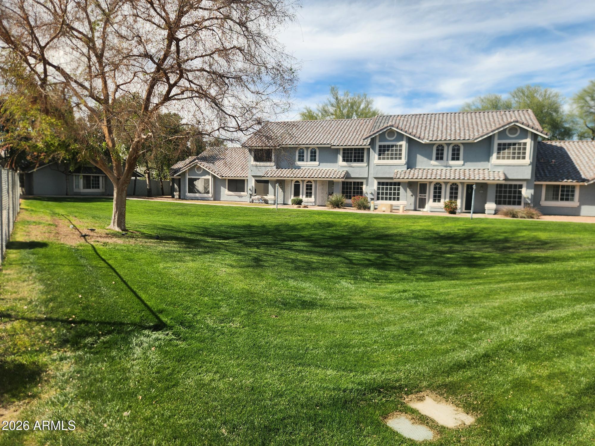 860 North McQueen Road, Unit 1145 Chandler, AZ 85225 - Photo 61 of 63 a front view of a house with a yard