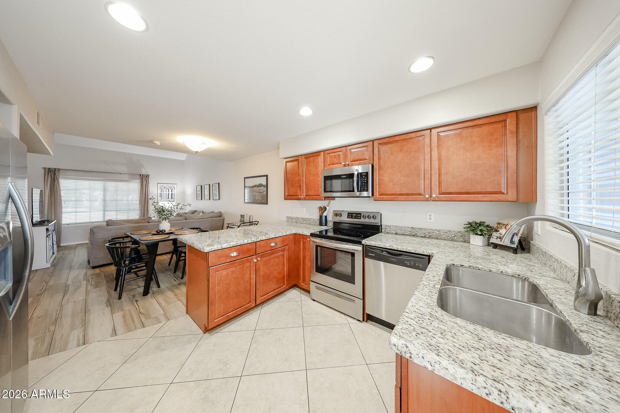 860 North McQueen Road, Unit 1145 Chandler, AZ 85225 - Photo 8 of 63 a kitchen with stainless steel appliances granite countertop sink stove top oven and cabinets