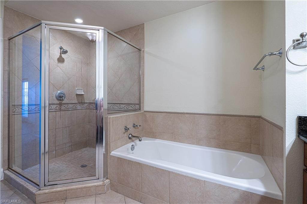 1362 Centre Ct Ridge Drive, Unit 101 Reunion, FL 34747 - Photo 17 of 25 Bathroom with tile flooring and plus walk in shower