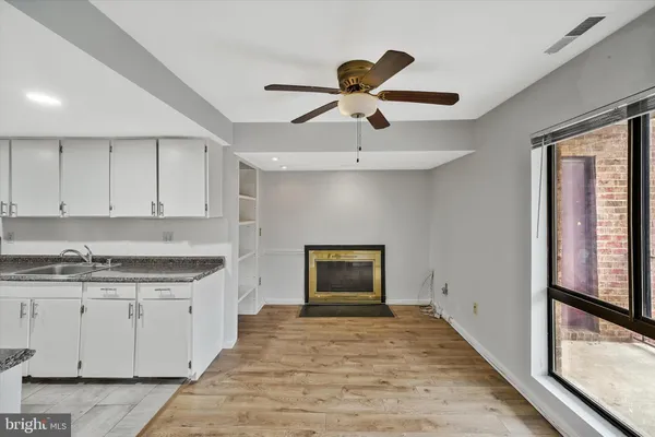 a kitchen with granite countertop a stove and a wooden floors