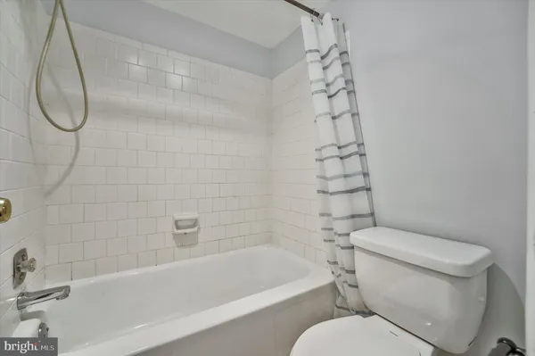 a bathroom with a toilet and a bathtub