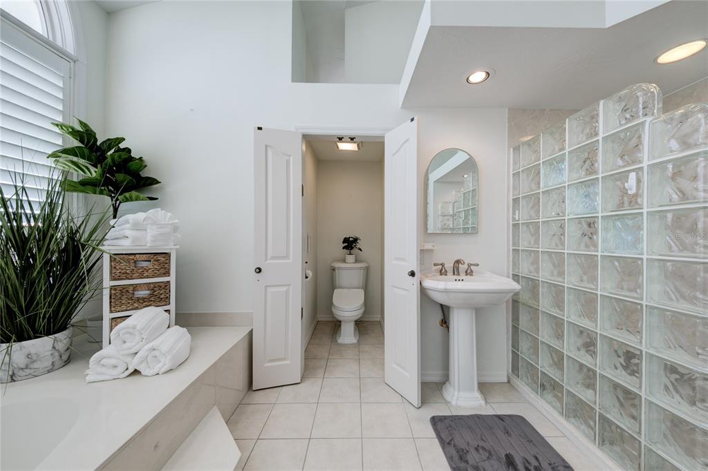 624 South Casey Key Road Nokomis, FL 34275 - Photo 11 of 75 a spacious bathroom with a granite countertop sink and a mirror