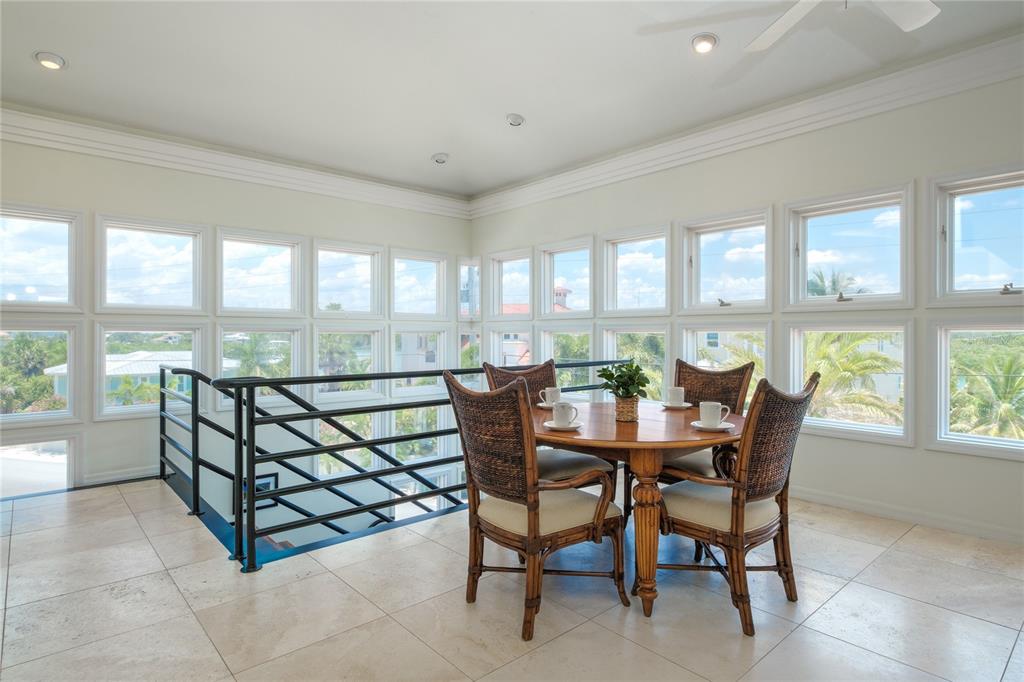 624 South Casey Key Road Nokomis, FL 34275 - Photo 15 of 75 a view of a dining room and livingroom with furniture a rug and a large window