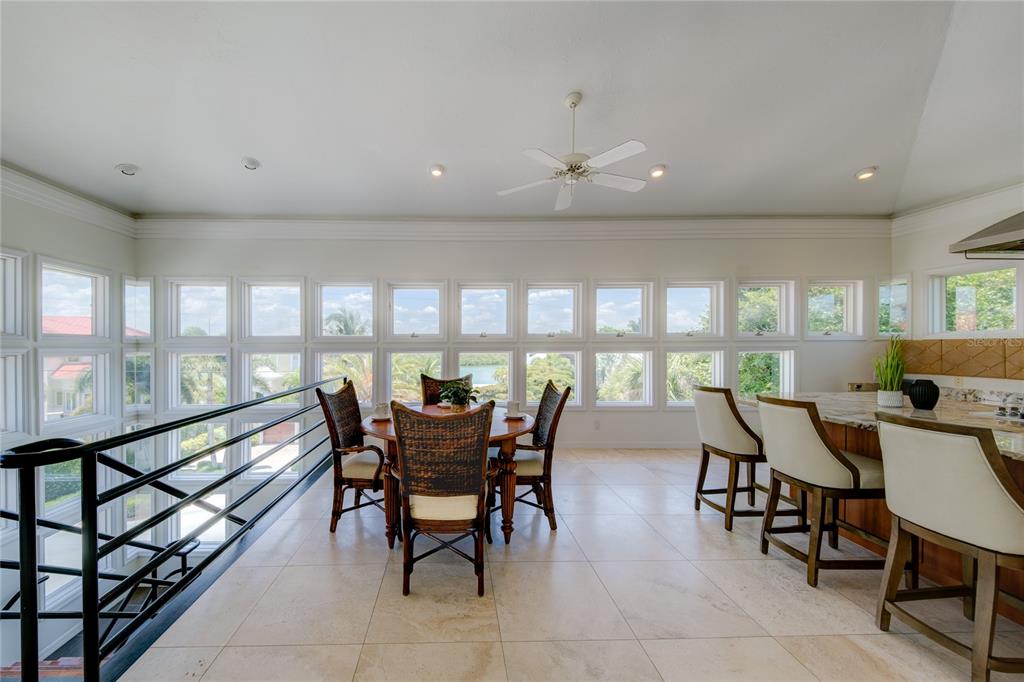 624 South Casey Key Road Nokomis, FL 34275 - Photo 17 of 75 a view of a dining room with furniture and a large window