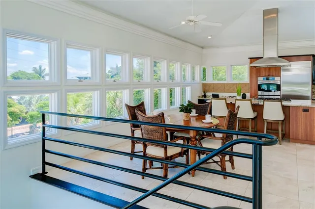 a dining room with furniture a large window and wooden floor