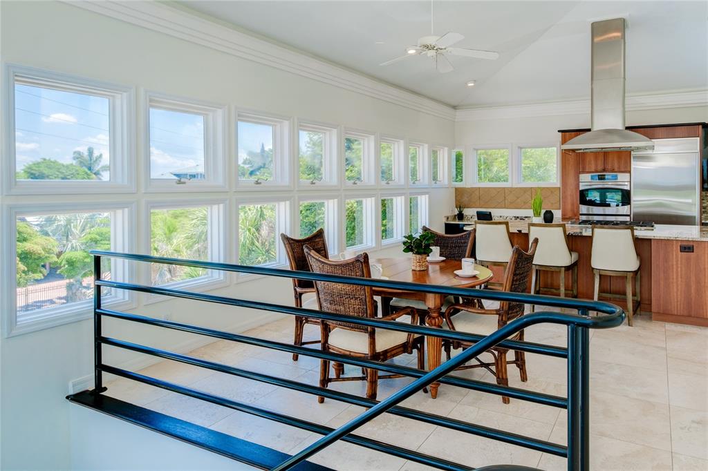 624 South Casey Key Road Nokomis, FL 34275 - Photo 18 of 75 a dining room with furniture and a floor to ceiling window