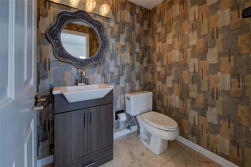 624 South Casey Key Road Nokomis, FL 34275 - Photo 35 of 75 a bathroom with a sink a toilet and a mirror