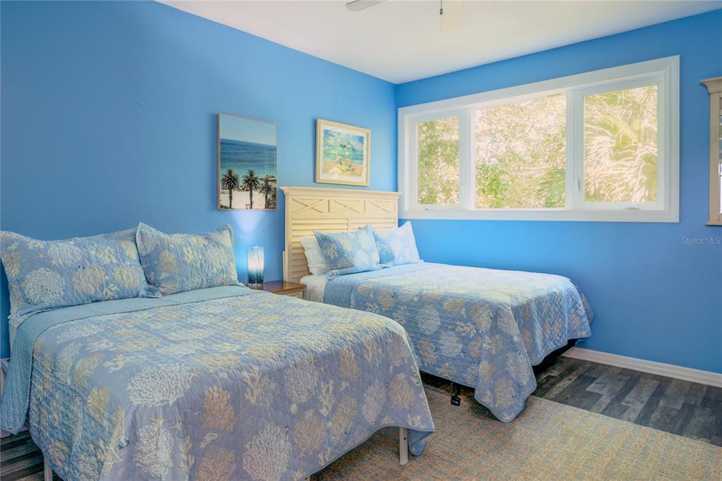 624 South Casey Key Road Nokomis, FL 34275 - Photo 37 of 75 a bedroom with two beds and a large window