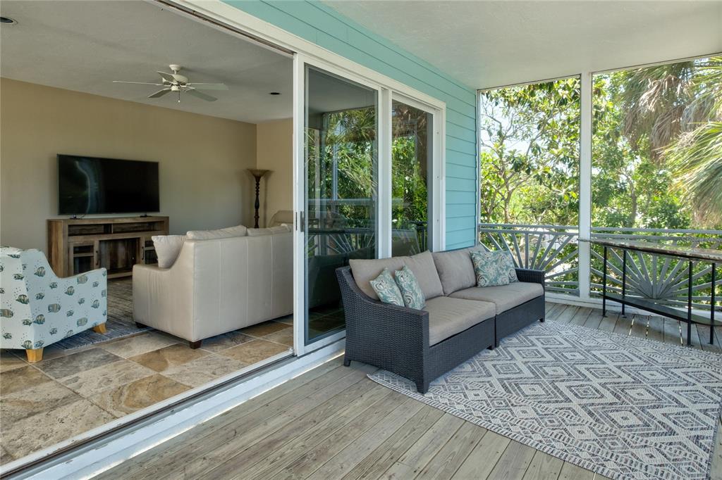 624 South Casey Key Road Nokomis, FL 34275 - Photo 48 of 75 a living room with furniture and a flat screen tv