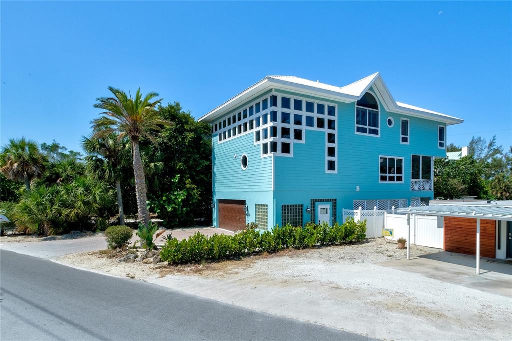 624 South Casey Key Road Nokomis, FL 34275 - Photo 58 of 75 a front view of a house with a garden