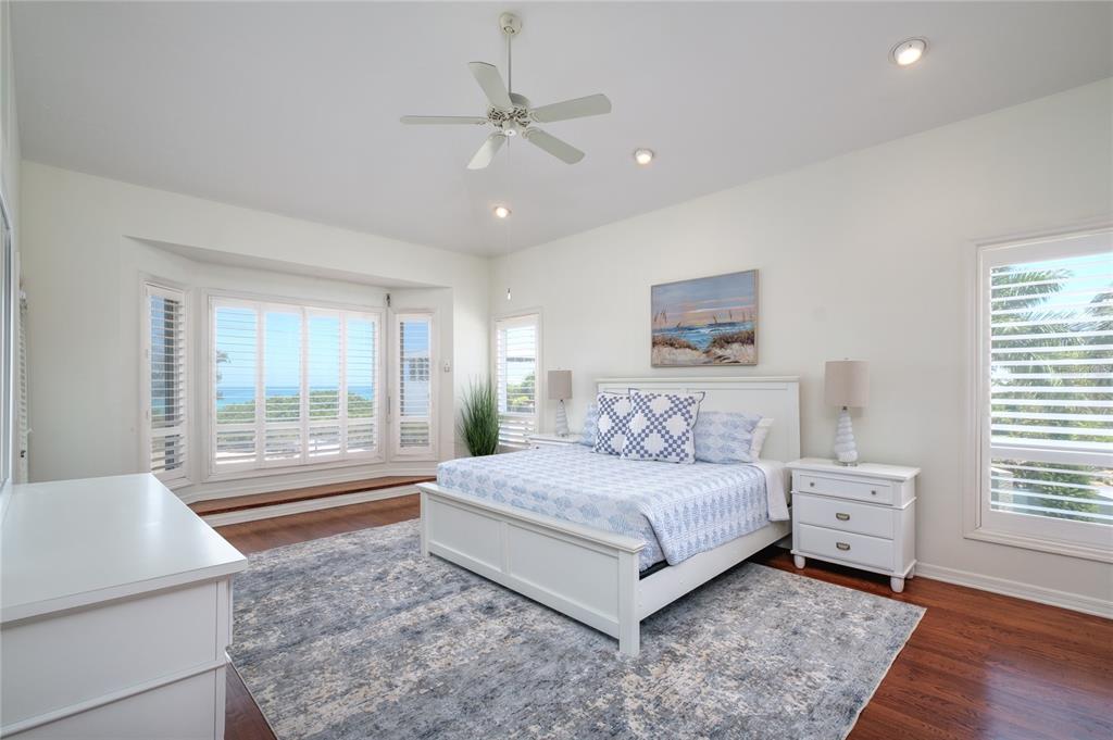 624 South Casey Key Road Nokomis, FL 34275 - Photo 6 of 75 a bedroom with a large bed and a window