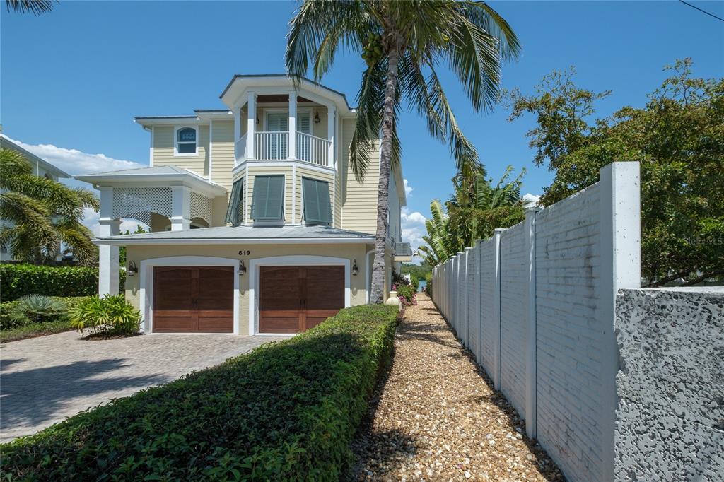 624 South Casey Key Road Nokomis, FL 34275 - Photo 70 of 75 a front view of a house with a yard and trees