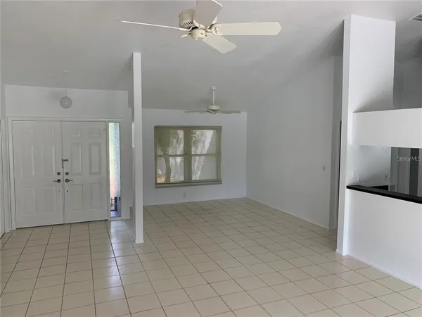 an empty room with closet and windows