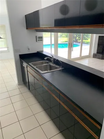 a kitchen with a sink a counter top space and a window