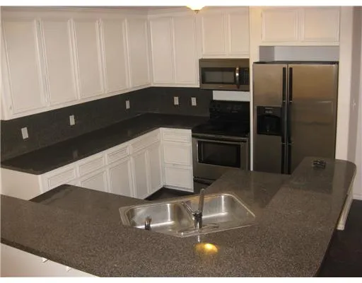 a kitchen with a refrigerator and cabinets