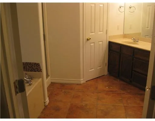 a view of bathroom with a sink and mirror
