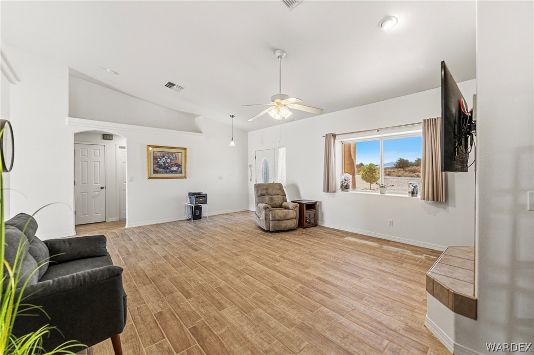 9332 Branded Road Kingman, AZ 86401 - Photo 6 of 44 a spacious bedroom with a bed a couch and a window