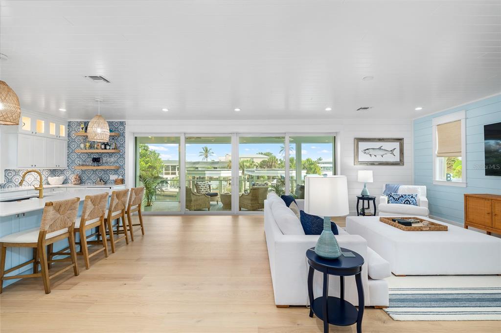180 Damfiwill Street Boca Grande, FL 33921 - Photo 13 of 83 a large white kitchen with a large window and furniture