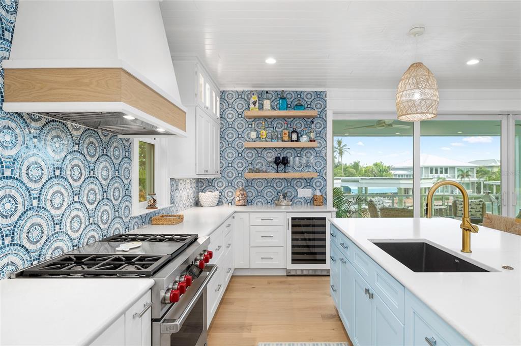 180 Damfiwill Street Boca Grande, FL 33921 - Photo 18 of 83 a kitchen with stainless steel appliances granite countertop a sink stove and cabinets