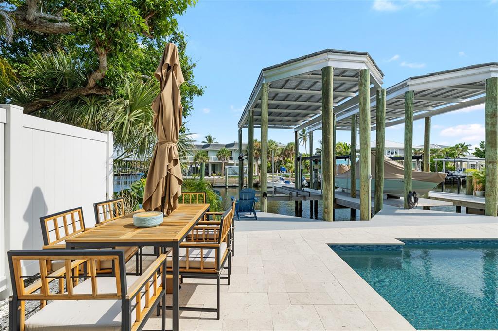 180 Damfiwill Street Boca Grande, FL 33921 - Photo 28 of 83 a view of a patio with a table and chairs