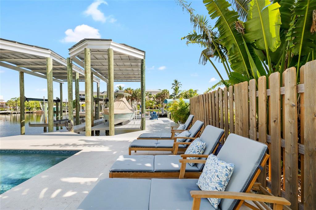 180 Damfiwill Street Boca Grande, FL 33921 - Photo 33 of 83 a view of an chair and tables in the patio