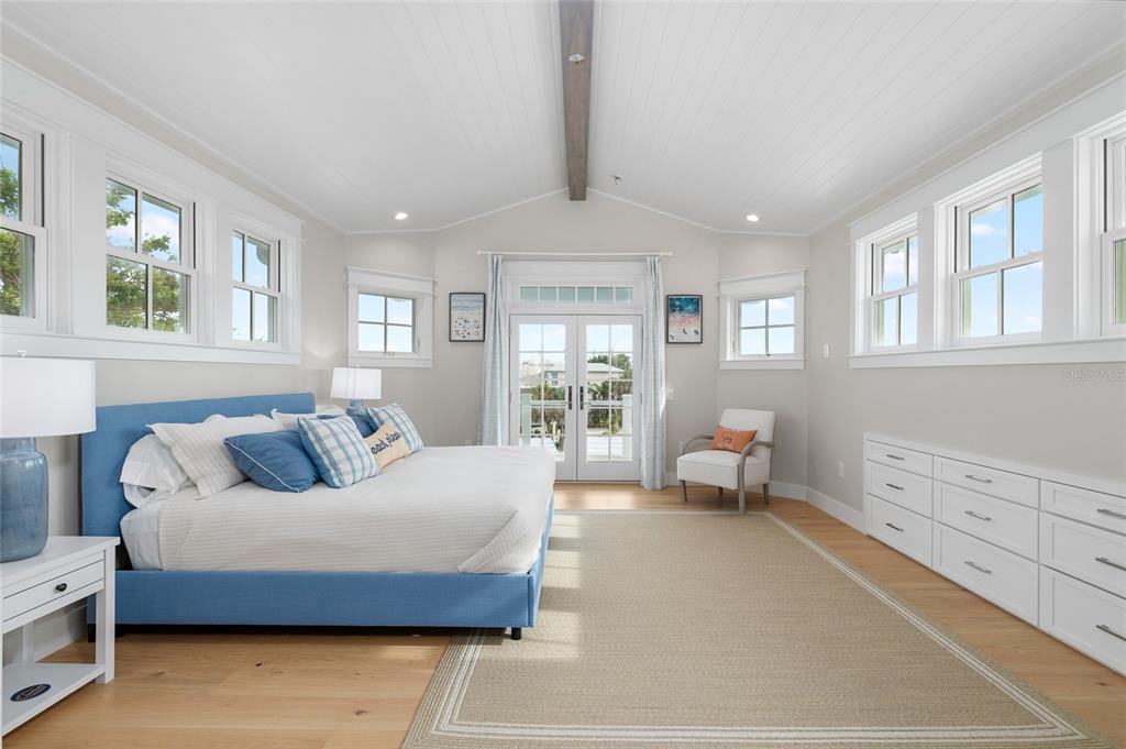 180 Damfiwill Street Boca Grande, FL 33921 - Photo 42 of 83 a bedroom with a bed and wooden floor