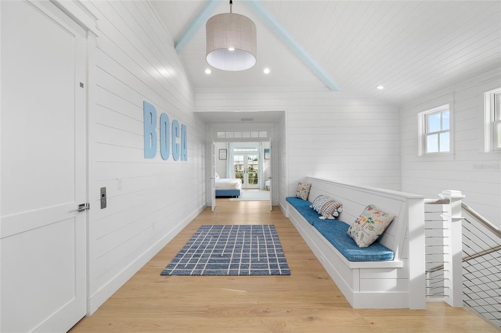 180 Damfiwill Street Boca Grande, FL 33921 - Photo 49 of 83 a view of a hallway with wooden floor and staircase