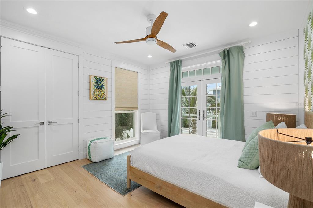 180 Damfiwill Street Boca Grande, FL 33921 - Photo 54 of 83 a bedroom with a bed and wooden floor