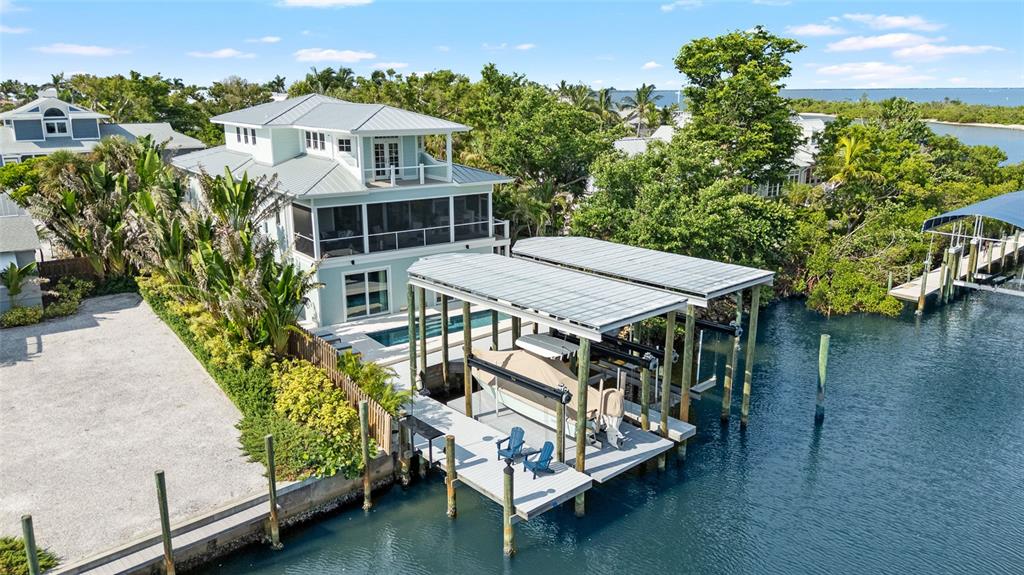 180 Damfiwill Street Boca Grande, FL 33921 - Photo 72 of 83 an aerial view of a house with balcony table and chairs