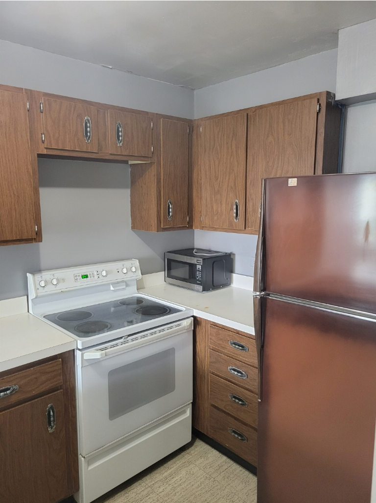 5415 North Sheridan Road, Unit 609 Chicago, IL 60640 - Photo 23 of 25 a kitchen with appliances and cabinets