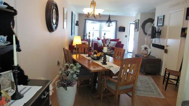 a view of a dining room with furniture and a chandelier