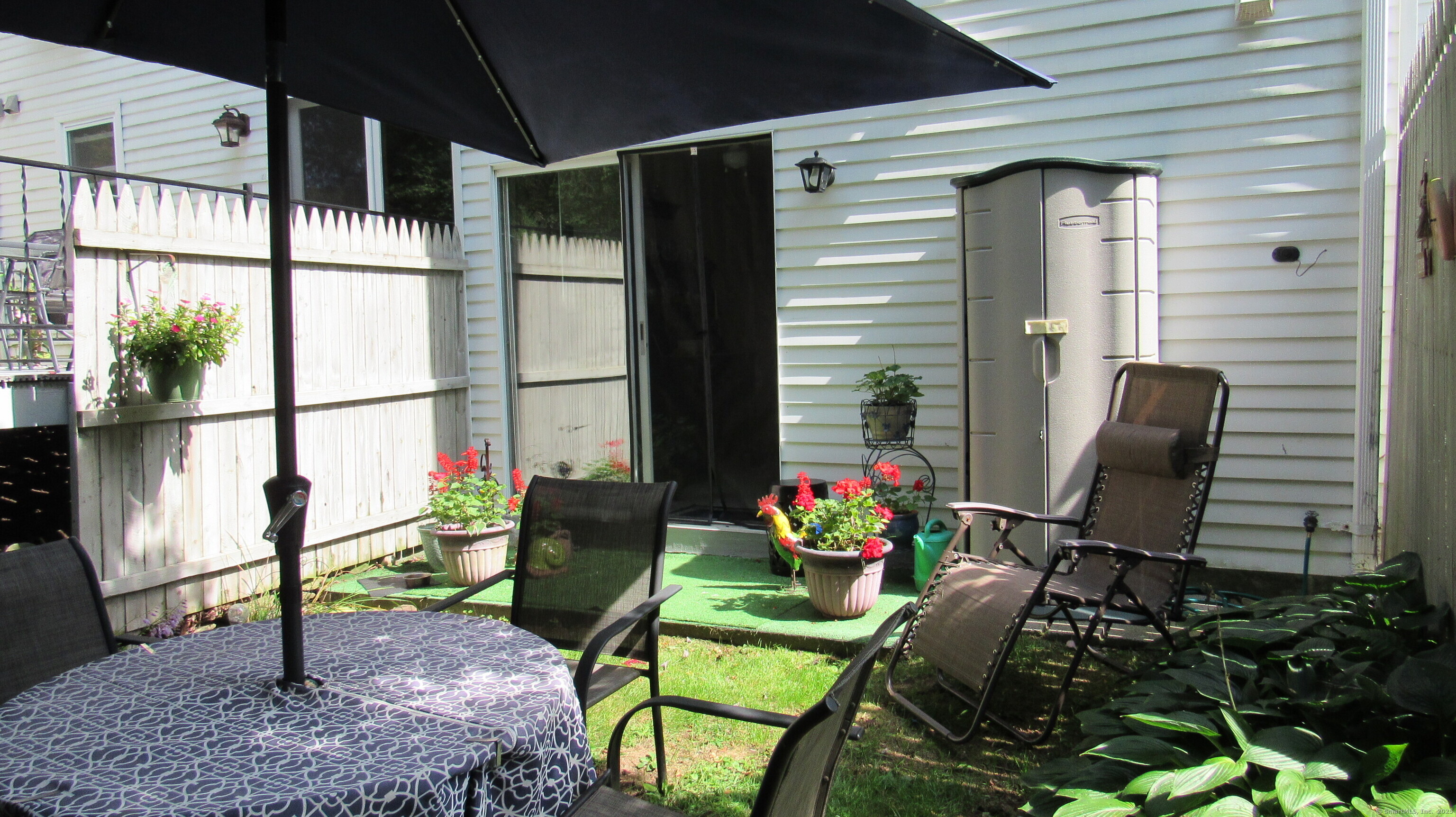 27 Surrey Lane, Unit 27 Torrington, CT 06790 - Photo 29 of 30 a front view of a house with outdoor seating and flowers
